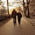 elderly couple, walking, park, trees, nature, outdoors, exercise, arm in arm, walking arm in arm, impaired vision, monochrome, sepia
